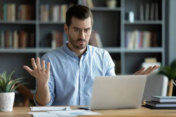 Man looks confused sitting behind computer | What is penetration testing in cyber security?
