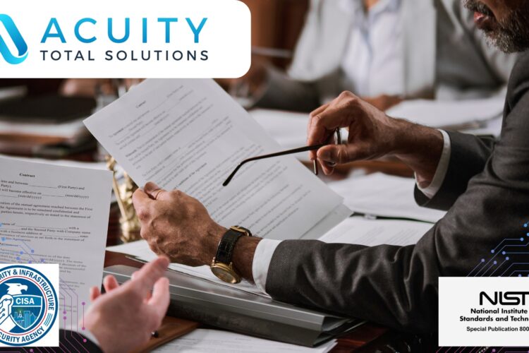 two people sit at a desk and review contract paperwork